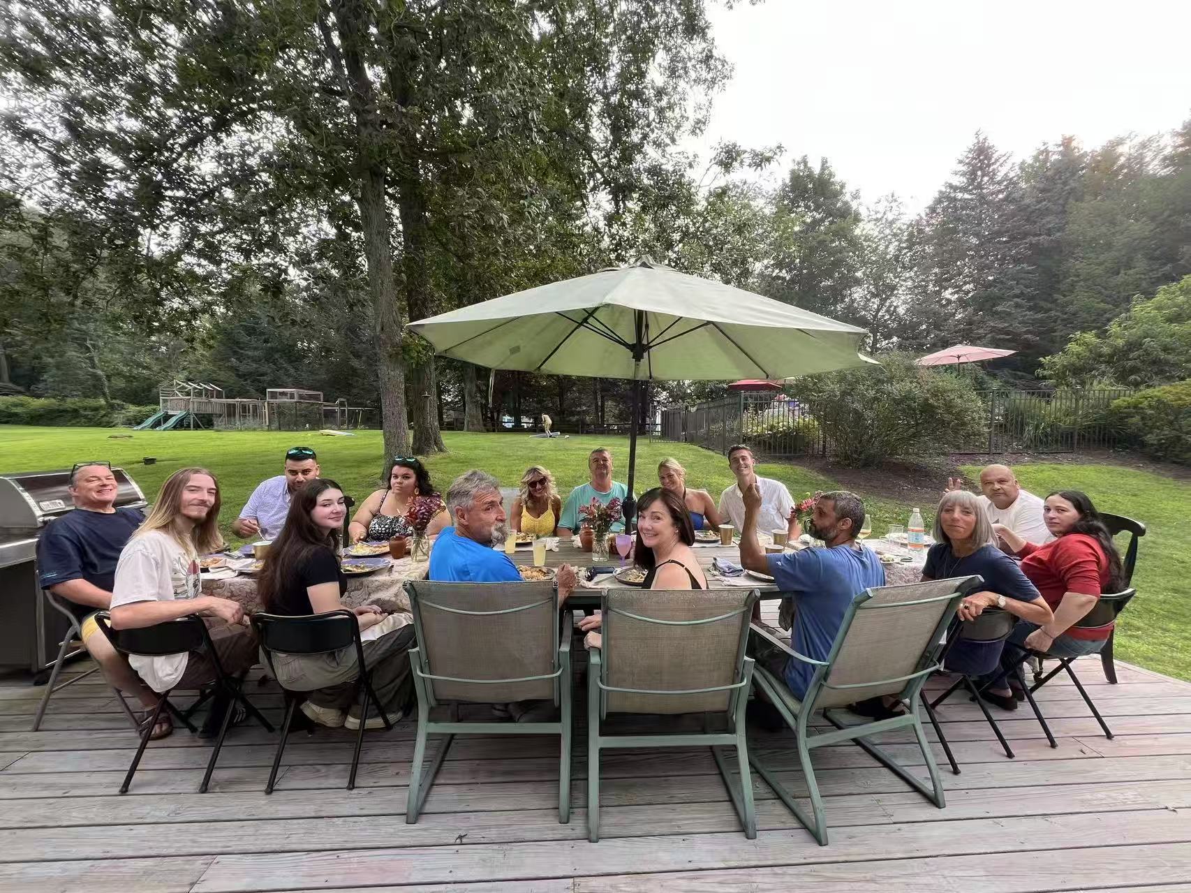 Guests enjoying a backyard hibachi dinner
